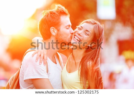 Image, Stock Photo Young ethnic man kissing cheek of smiling girlfriend working remotely on netbook in cafeteria