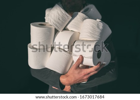 Toilet paper shortage coronavirus panic buying man hoarding carrying many rolls at home in fear of corona virus outbreak closing shopping stores. Stock foto © 