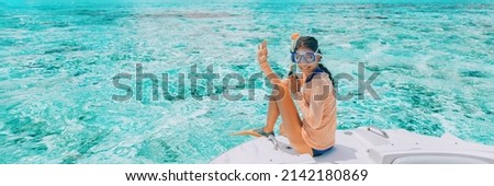 Woman going snorkeling in pefect clear water at coral reef. Happy tourist on luxury vacation getaway on cruise ship luxury yacht private charter swim tour of coral reefs Сток-фото © 