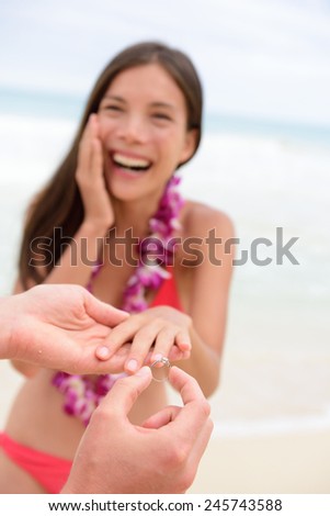 Marriage proposal casual couple beach wedding concept. Man proposing to girlfriend during holiday travel. Young lovers in love.