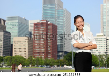 Businesswoman in Tokyo city skyline, Japan. Beautiful young casual professional woman standing portrait for Japanese business concept in Japan.