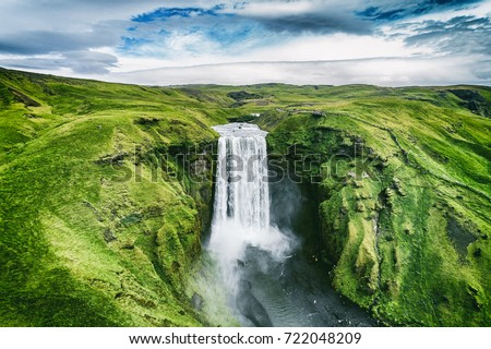 Iceland waterfall Skogafoss in Icelandic nature landscape. Famous tourist attractions and landmarks destination in Icelandic nature landscape on South Iceland. Aerial drone view of top waterfall. Stock foto © 