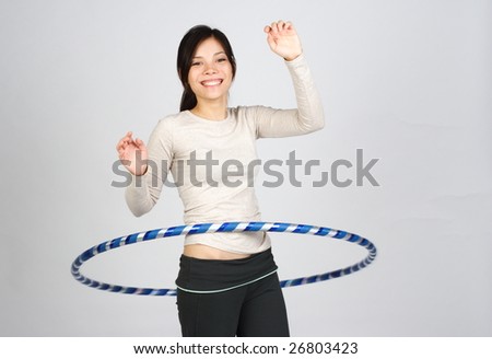 happy girl doing hula hoop