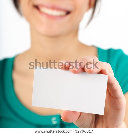 Beautiful young woman with big smile displaying blank business card. Shallow depth of field, focus on card. Isolated on white.