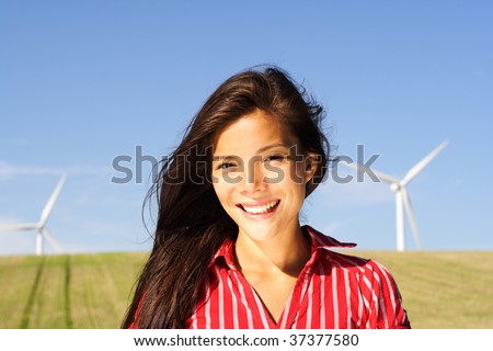Windturbines and smiling beautiful natural girl.