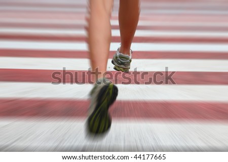 City Running. Closeup of woman running shoes in action on crosswalk in urban setting. Zoom blurred effect with shallow depth of field with focus on right running shoe.