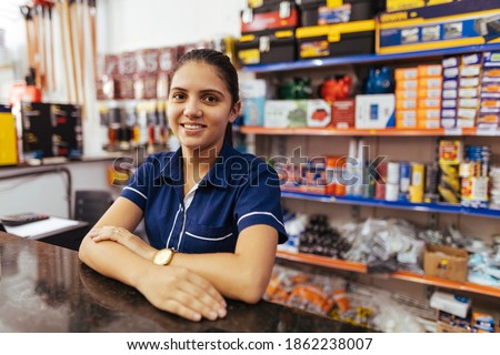 Young latin woman working in hardware store