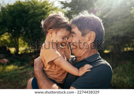 Similar – Foto Bild Älterer Mann und Junge essen Erdbeere im Garten