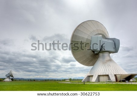 Satellite communiations installations - the type used for broadcasting. Poor weather.