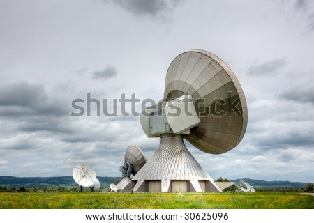 A satellite communications installation in a country setting. Poor weather.