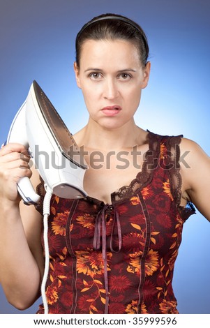 A young housewife fed up - holding an iron