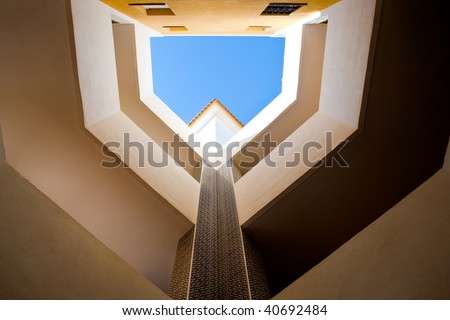 Looking up in a European style courtyard with natural light.