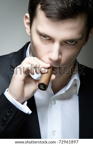 A Young Man Looking Suspicious With A Cigar Stock Photo 72961897 ...