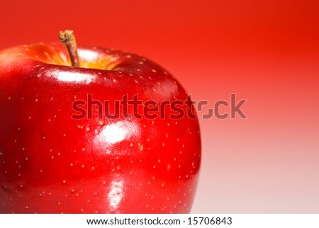 Shinny red apple on red gradient background