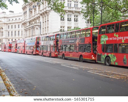 LONDON, ENGLAND, UK - OCTOBER 23: Row of double decker red buses waiting to depart from on October 23, 2013 in London, England, UK