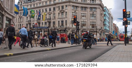 LONDON, ENGLAND, UK - SEPTEMBER 10, 2012: Oxford Street is one of the busiest high streets with tourist strolling in the winter shopping season