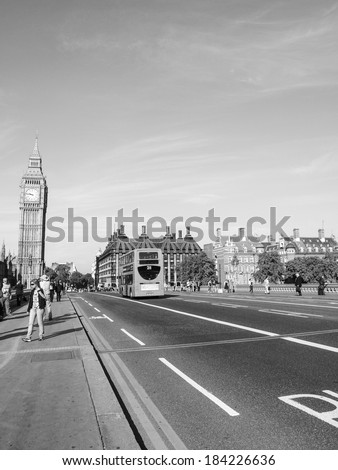 LONDON, ENGLAND, UK - SEPTEMBER 8: Tourists and a traditional double decker red bus crossing Westminster Bridge on September 8, 2012 in London, England, UK