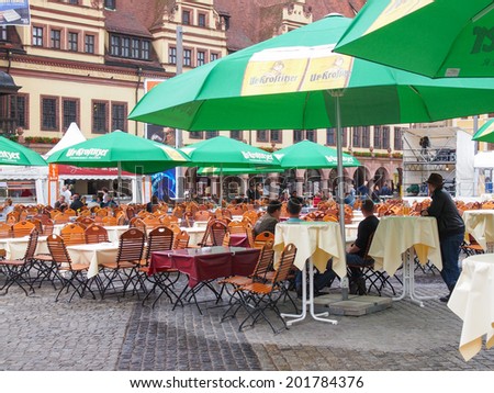 LEIPZIG, GERMANY - JUNE 14, 2014: People in beer garden at the Bachfest annual summer music festival celebrating baroque musician Johann Sebastian Bach in his town
