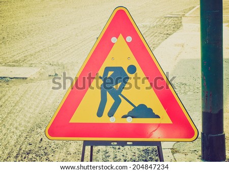 Vintage retro looking Road works traffic sign for construction site