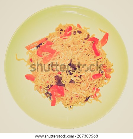 Vintage retro looking Curry noodles pasta traditional Indian and Japanese Asian food in a dish isolated over white background