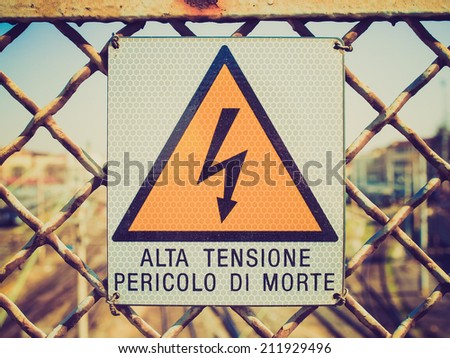 Vintage retro looking Sign of risk of electric shock by electrocution - in Italian