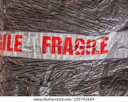 Fragile warning sign label tag on a packet parcel for mail post shipping