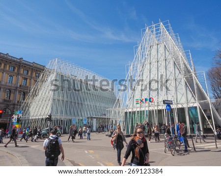 MILAN, ITALY - MARCH 28, 2015: Tourists in front of the Expo Gate information centre in Milan as part of the Expo Milano 2015 international exhibition
