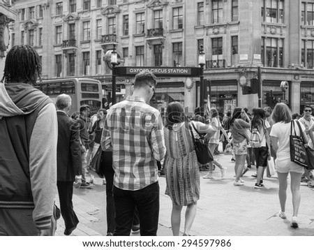 LONDON, UK - JUNE 12, 2015: Travellers at Oxford Circus underground station in black and white