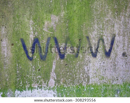 Www internet address url written with black paint on a grunge gray concrete wall with green moss