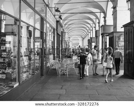 TURIN, ITALY - JUNE 19, 2015: Tourists in Via Po ancient central baroque street in black and white