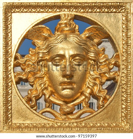 Ancient baroque golden mask on Palazzo Reale (The Royal Palace) fence in Turin Italy