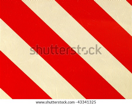 Reflective red and white stripes on a traffic sign
