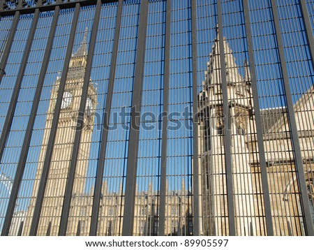 Houses of Parliament Westminster Palace London gothic architecture seen from behind a security fence gate