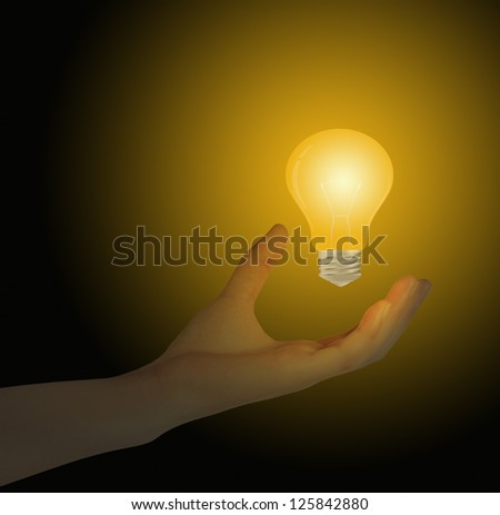 Light bulb in hand on gray background
