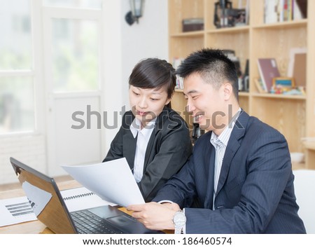 Two business people Having Meeting Around Table In Modern Office
