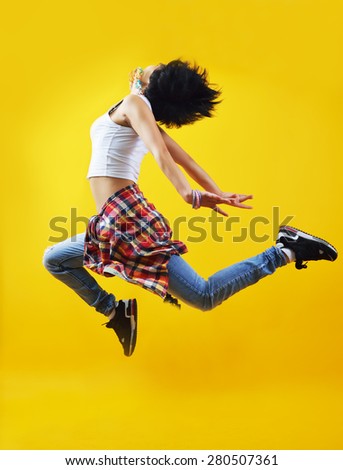 Beautiful young hip-hop dancer, jumping in the air