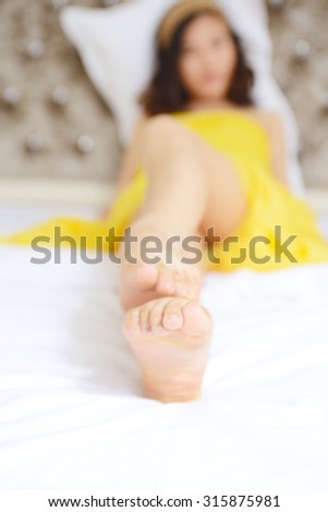 Sexy Asian girls lying in bed, feet macro
