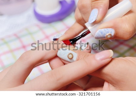 Woman getting artificial nails done, selective focus