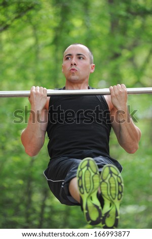 Young man training sport on horizontal bar