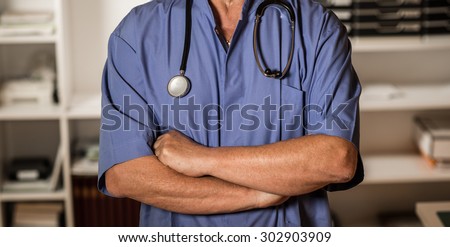 Doctor posing in his office