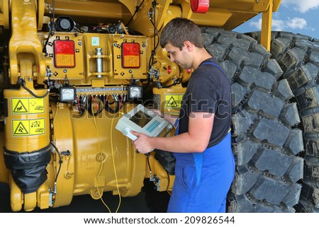 Germany Kaufbeuren circa July 2014: Service Mechanic in the review of a dump truck
