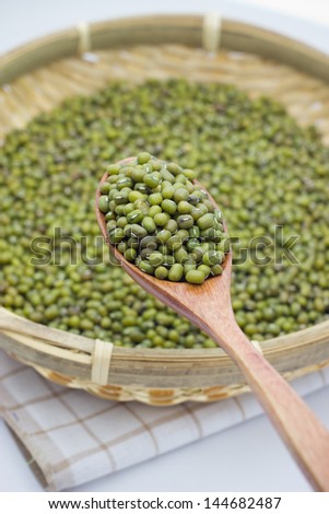 green mung beans over the wooden spoon