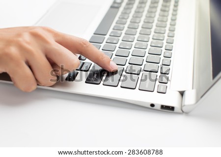 Woman hand press on laptop, close up