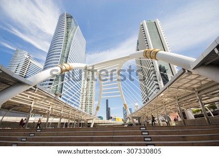 BANGKOK - Aug 18: View of high buildings and public sky walk for transit between Sky Transit and Bus Rapid Transit Systems at Sathorn-Narathiwas junction on Aug 18, 2015 in Bangkok, Thailand.