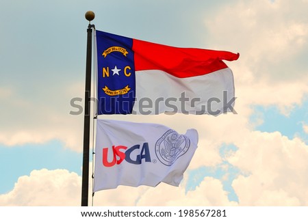 PINEHURST, NORTH CAROLINA/USA - JUNE 11 USGA and North Carolina Flags flying high at 2014  U.S. Open Golf Championship at the Pinehurst No. 2 course on June 11, 2014 in Pinehurst, North Carolina USA.