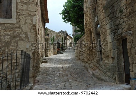 Cobblestoned street lined with stone cottages.