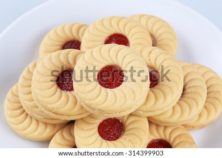 Butter Cookies in white ceramic dish , Strawberry cracker , Sweet cookies , Sandwich cream cookies.
