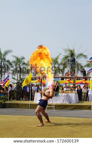 PHETCHABUN,THAILAND - December 29, 2013:Young man blowing fire in the New Year Festival and Wai Pho Khun Pha Muang.On December 29, 2013 in Phetchabun province, Thailand.
