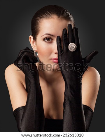 Glamorous Woman in Black Gloves with a Circular Ring