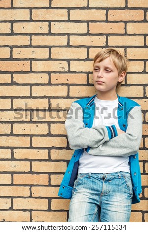Portrait of a boy on a background of a brick wall